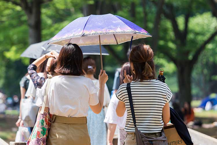 紫外線から肌を守る日焼け止めと日傘。