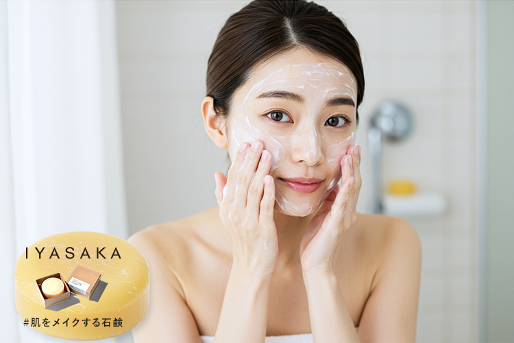 きめ細かい泡で洗顔する女性。手前にはベージュがかった黄色の丸い石鹸が映る。